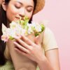 Can scent affect your mood? Definitely! This woman is calmed and happy after smelling flowers.